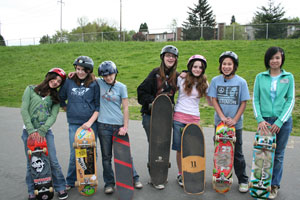 female skateboards hanging out with their boards in hand